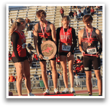 Three girls standing on a podium. Description generated by AI