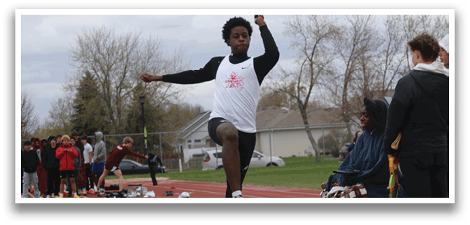A man is jumping in the air on a track. Description generated by AI