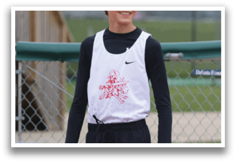 A boy wearing a white shirt and black shorts. Description generated by AI