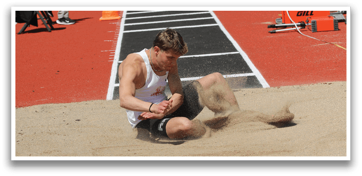 A man is sitting in the sand. Description generated by AI