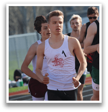 A group of runners on a track. Description generated by AI