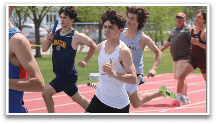 A group of young men running on a track. Description generated by AI