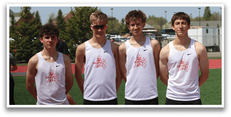 Four young men wearing white shirts and black shorts. Description generated by AI