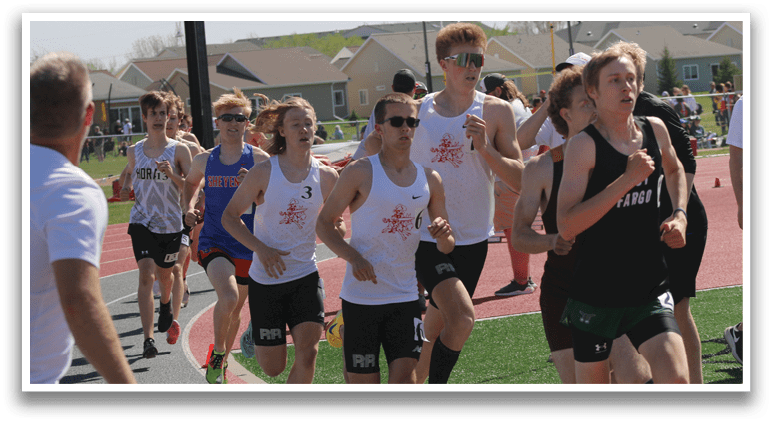 A group of people running on a track. Description generated by AI
