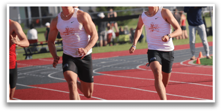 A group of men running on a track. Description generated by AI
