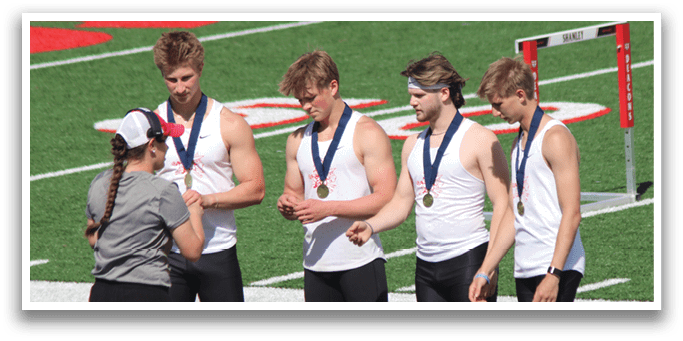 A group of men wearing medals. Description generated by AI