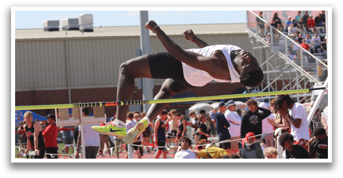 A man is jumping over a barrier. Description generated by AI