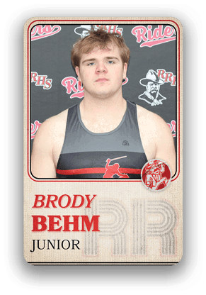 Person wearing a sleeveless athletic shirt with a baseball player graphic stands in front of a backdrop featuring the letters RRHS and the word Riders, with the name Brody Behm and the word Junior displayed below. Description generated by AI