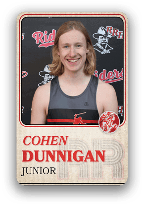 Person with shoulder-length hair wearing a sleeveless sports jersey with a red and black design standing in front of a backdrop featuring the word “Riders" and a logo, with text below reading "Cohen Dunnigan Junior." Description generated by AI