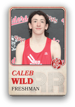 A person wearing a red sports jersey with the text “RED" and "WILD" on a card labeled "Caleb Wild Freshman" in front of a backdrop with "RRHS" and "Raiders" logos. Description generated by AI