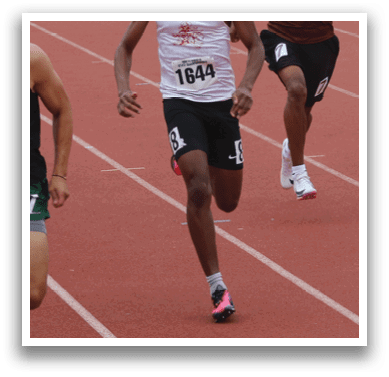 Four men wearing white shirts and black shorts are walking on a field. Description generated by AI