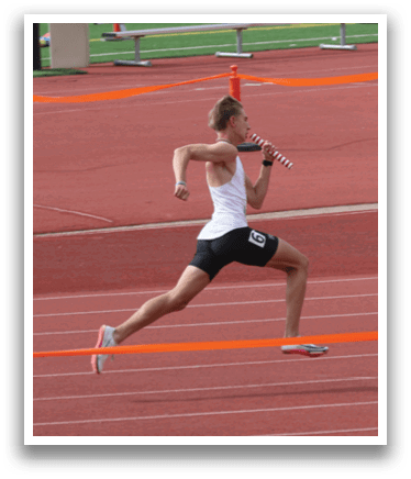 A man running on a track with a white tank top and black shorts. Description generated by AI