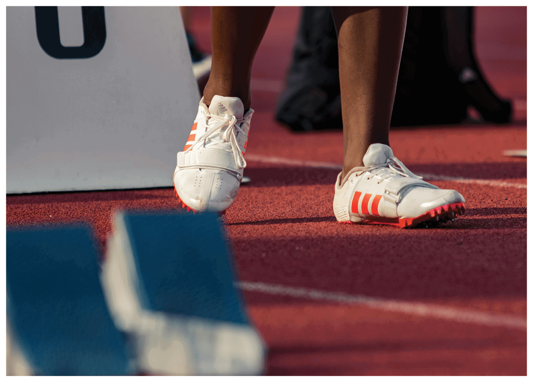 A person wearing white shoes is walking on a track. Contenido generado con IA