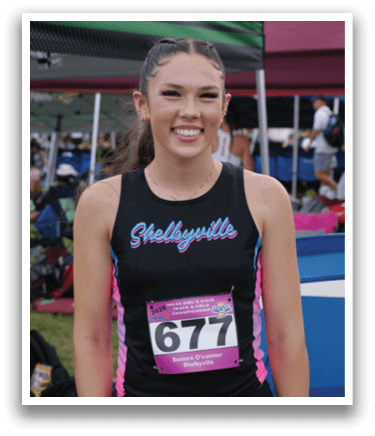 A woman is jumping in the air on a track, wearing a black and white outfit. Contenido generado con IA