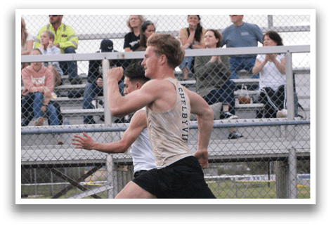 A man is running on a track in front of a crowd of people. Contenido generado con IA