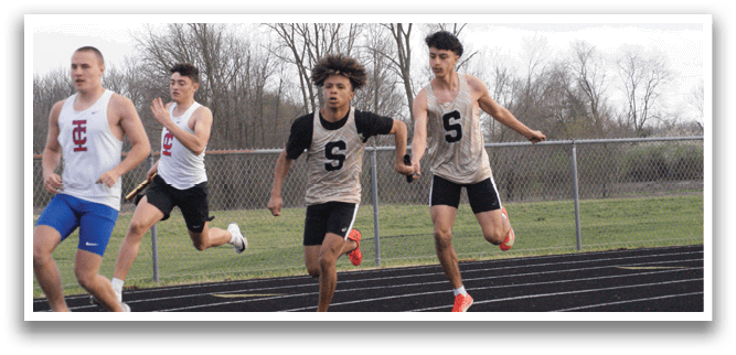Three men are running on a track, wearing shorts and shirts. One of the men is wearing a shirt with the letter “S" on it. Contenido generado con IA