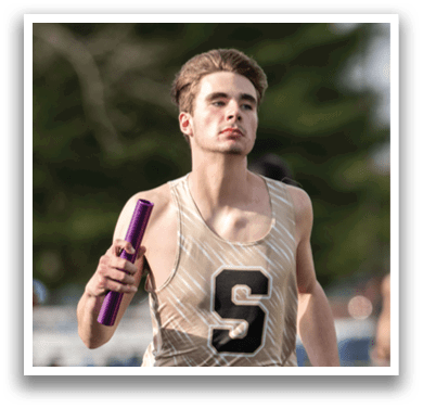 A man wearing a gold and black tank top is running on a track while holding a purple baton. Contenido generado con IA