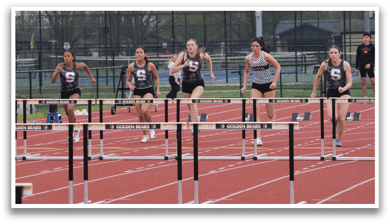 A group of women are running on a track, jumping over hurdles. Contenido generado con IA