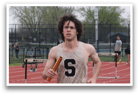 A man running on a track with a pole in his hand. Contenido generado con IA