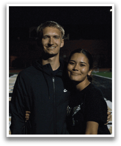 A man and woman standing on a football field, posing for a picture. Contenido generado con IA