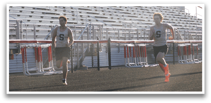 Two men are running on a track, one in front of the other. Contenido generado con IA