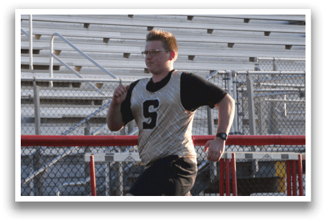 A boy running on a track with a number on his shirt. Contenido generado con IA