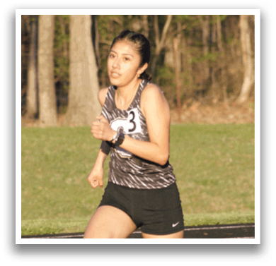 A woman is running on a track, wearing a black and white outfit. Contenido generado con IA