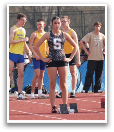 A group of people are standing on a track, some of them wearing shorts. Contenido generado con IA