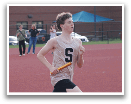 A man is running on a track while holding a baton. Contenido generado con IA