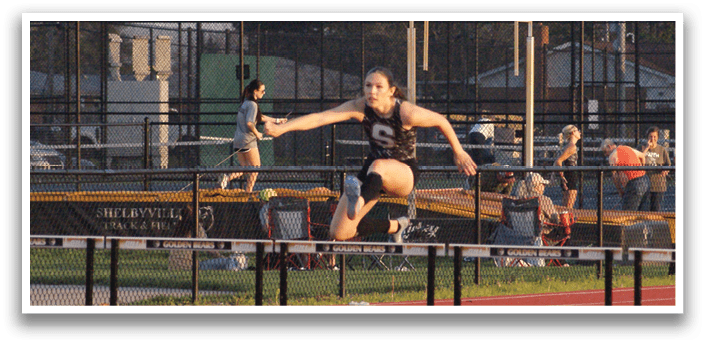 A woman is jumping over a hurdle in a track meet. Contenido generado con IA