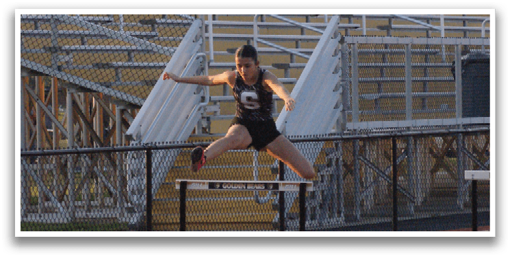 A person is jumping over a hurdle on a track. Contenido generado con IA