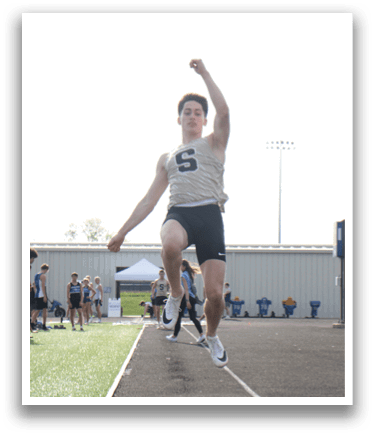 A man is jumping in the air, wearing a white shirt and black shorts. Contenido generado con IA