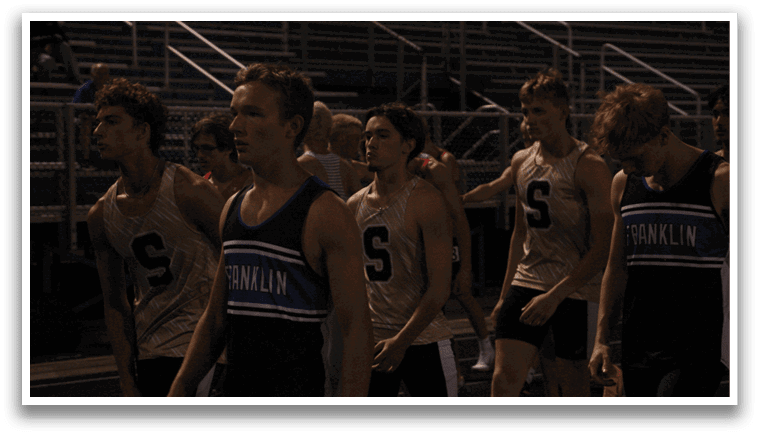 A group of young men wearing uniforms and running on a track. Contenido generado con IA