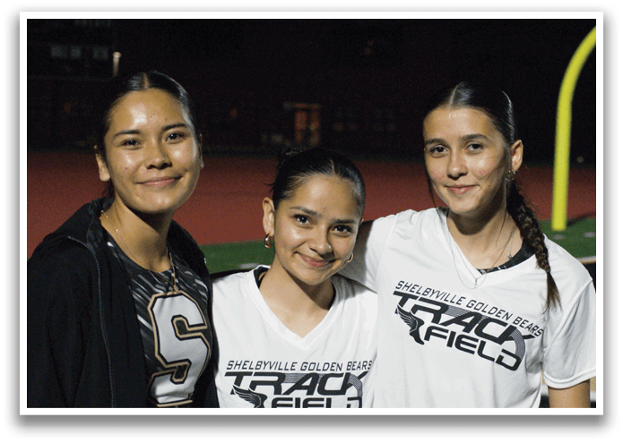 Three girls wearing white shirts and posing for a picture. Contenido generado con IA