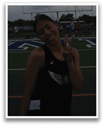 A woman posing for a picture on a football field. Contenido generado con IA