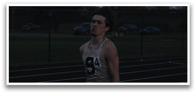 A man is running on a track with a number on his shirt. Contenido generado con IA