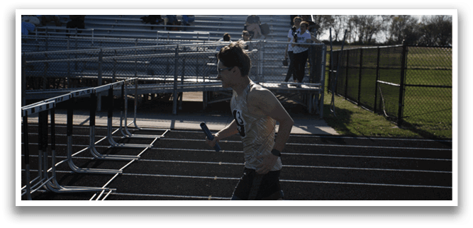 A man is running on a track with a pole in his hand. Contenido generado con IA