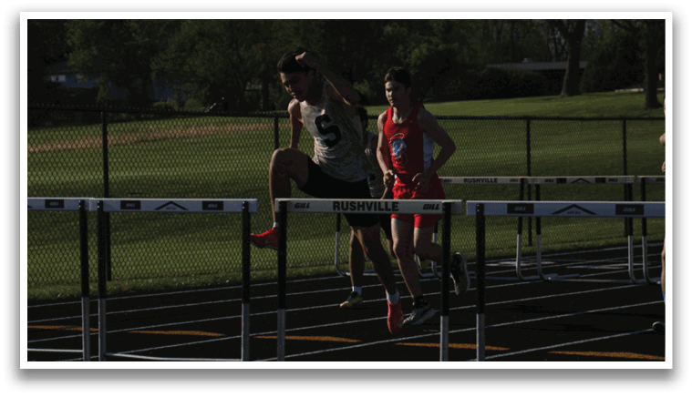 A man is jumping over a hurdle in a track meet. Contenido generado con IA