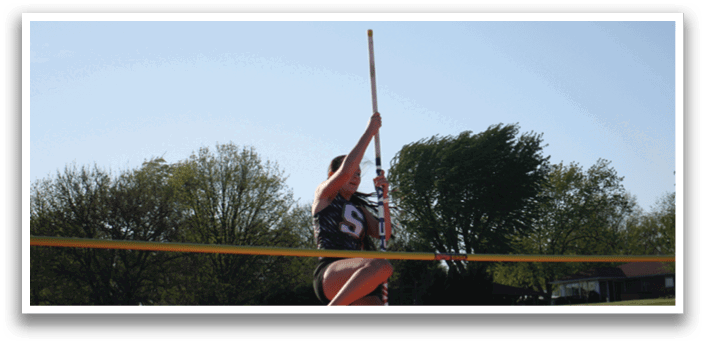 A woman is jumping in the air to hit a high jump bar. Contenido generado con IA