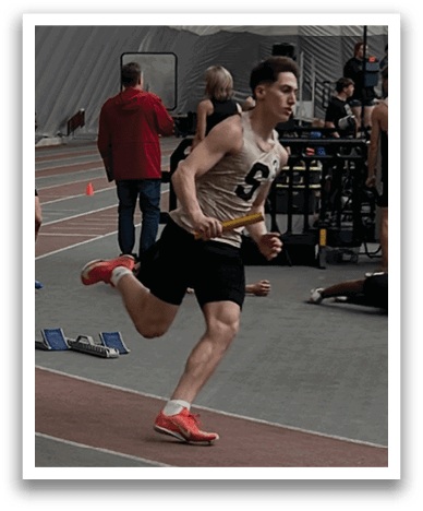 A man is running on a track while holding a baton. Contenido generado con IA