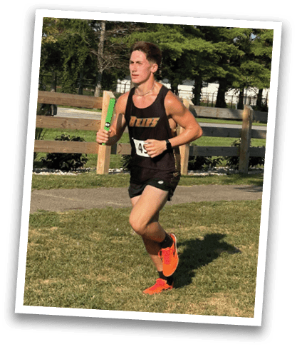 A man is running on a grassy field, wearing a black and white shirt. Contenido generado con IA