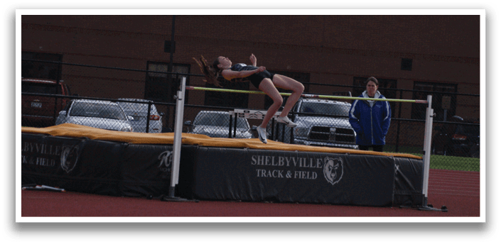 A woman is jumping over a barrier on a track. Contenido generado con IA