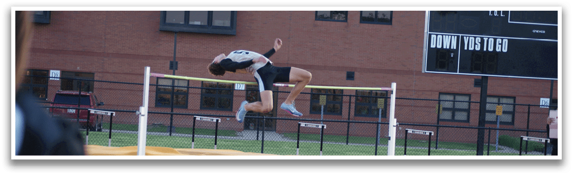 A person is jumping over a barrier on a track. Contenido generado con IA