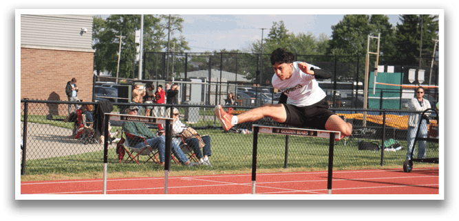 A man is jumping over a hurdle on a track. Contenido generado con IA