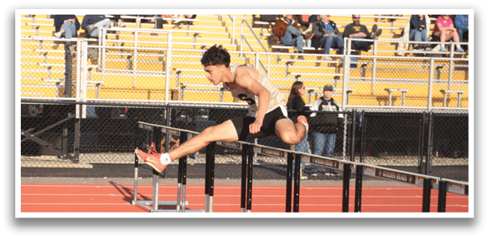 A man is jumping over a barrier in a track meet. Contenido generado con IA