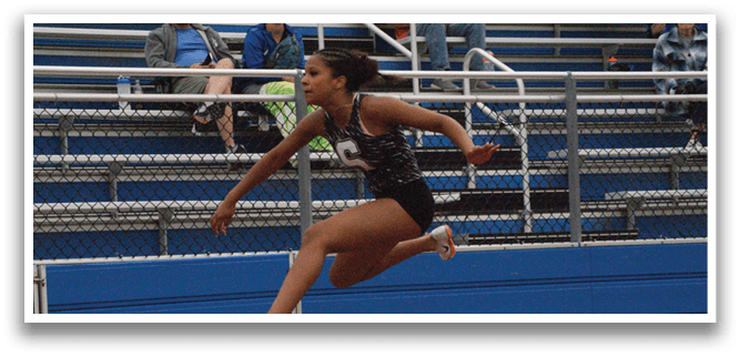 A woman is jumping over a hurdle in a track meet. Contenido generado con IA