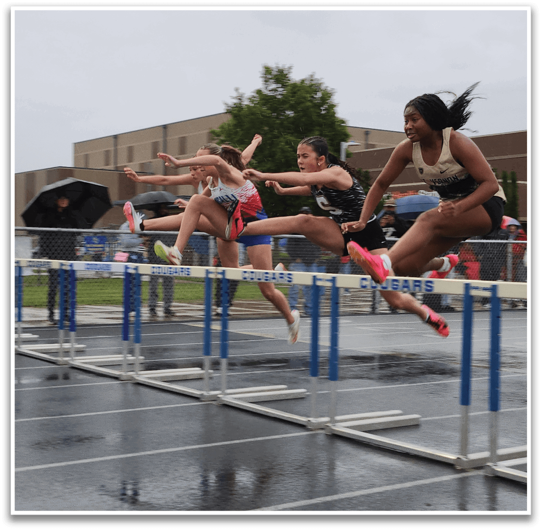 Three girls are jumping over a barrier in a competition. Contenido generado con IA