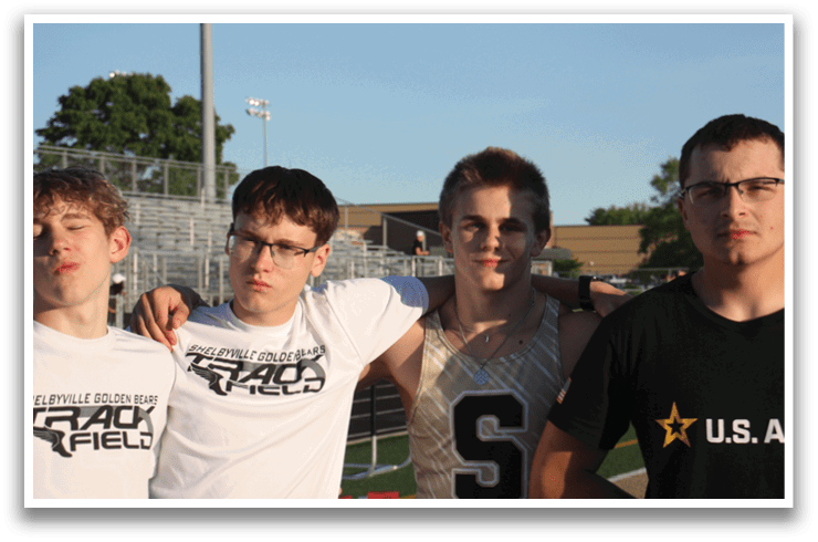 Four young men pose for a picture on a field, wearing glasses and white shirts. Contenido generado con IA