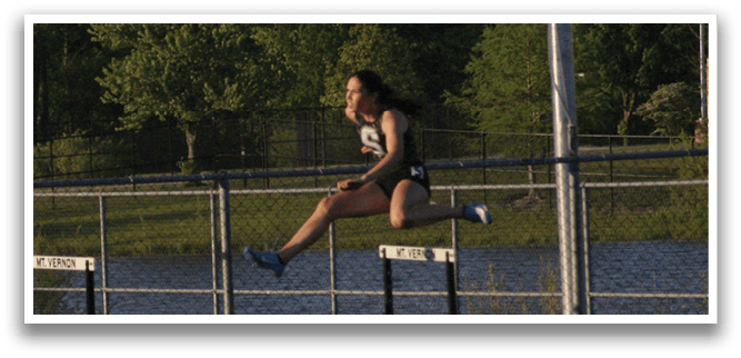 A woman is jumping over a hurdle on a track. Contenido generado con IA