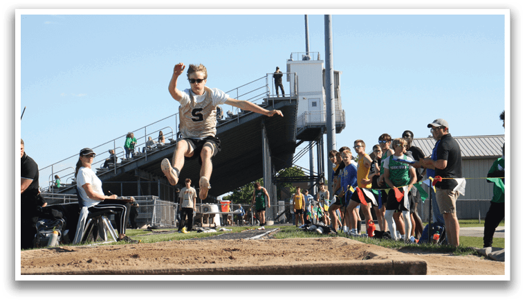 A man is jumping in the air over a hurdle, attempting to clear it. Contenido generado con IA